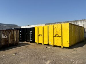 Rij gele schrootcontainers in diverse maten